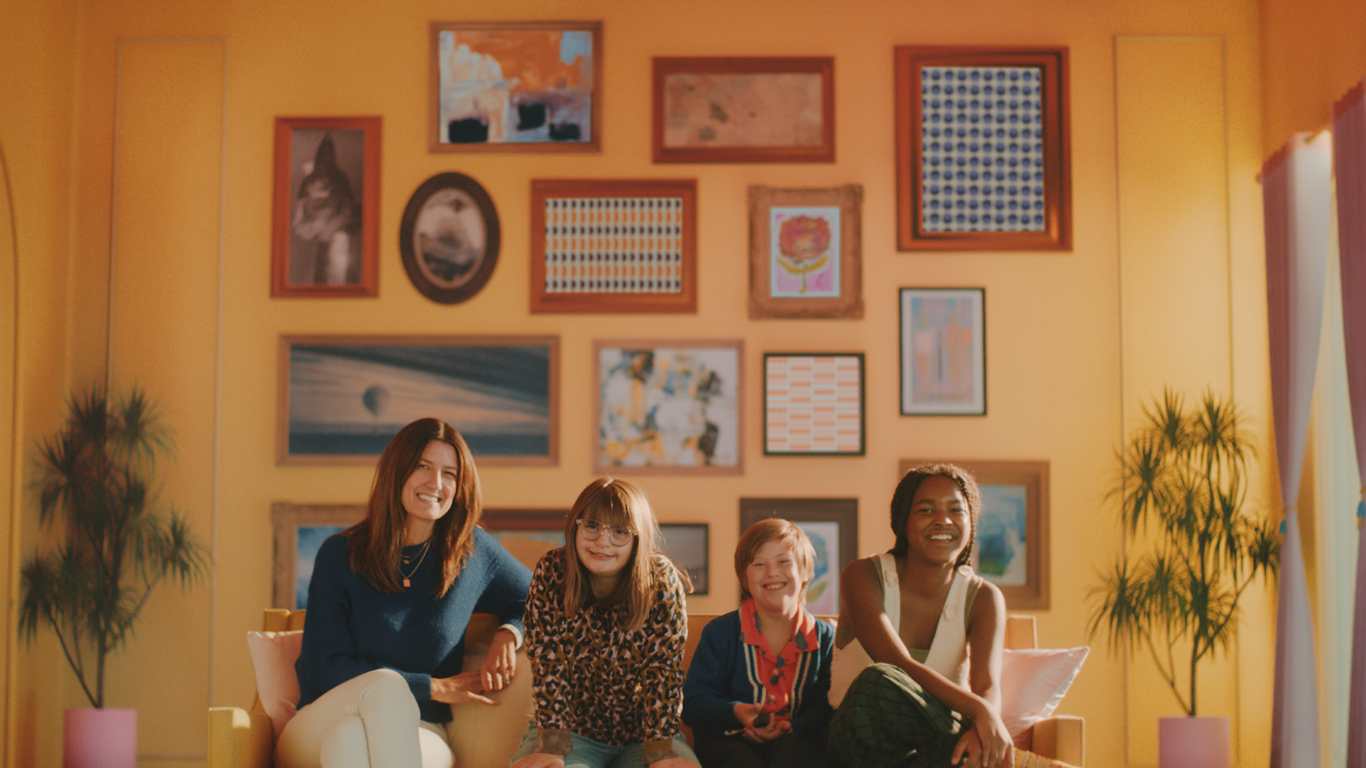 A group of 4 people sit on a couch