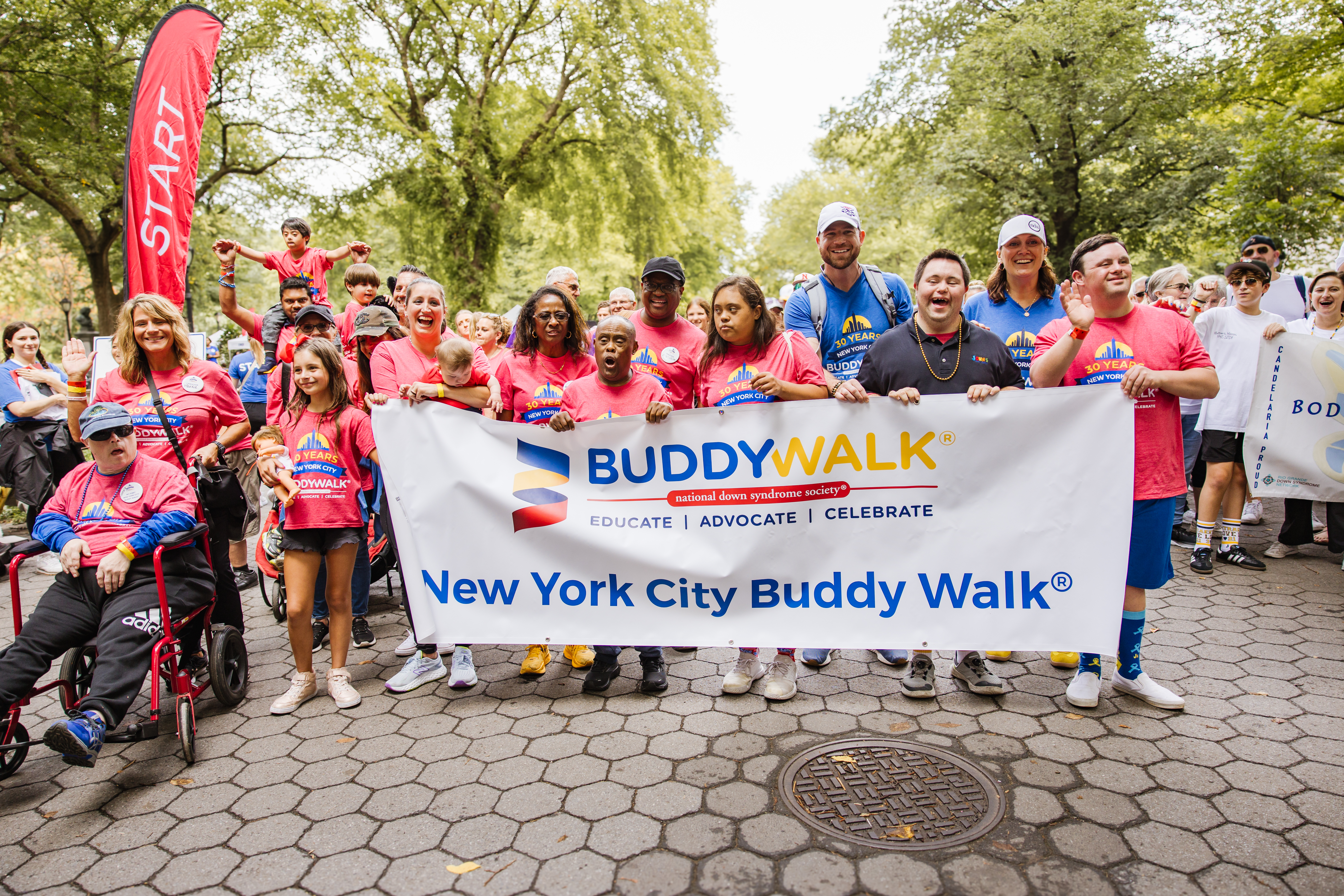 Walkers holding a sign at the start of the NYC Buddy Walk in Central Park