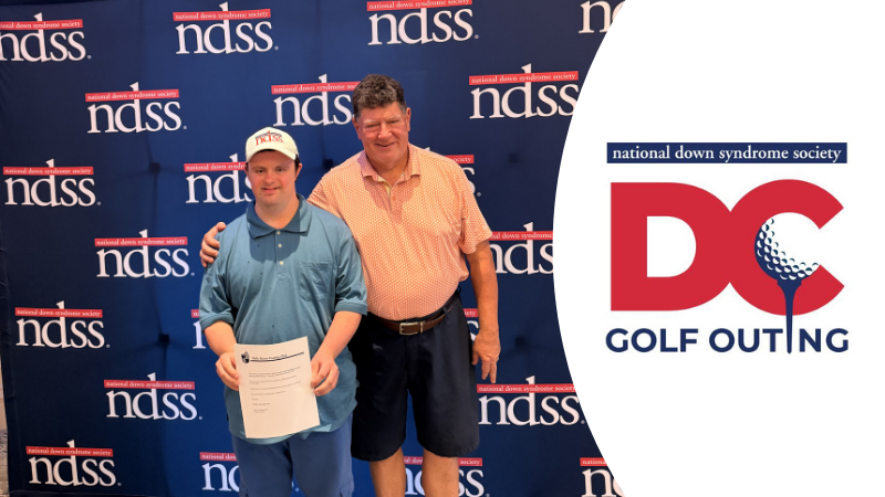 Photo of a young man with Down syndrome winning an award. He stands with another man, both wearing golfing clothes, in front of an NDSS banner. National Down Syndrome Society D.C. Golf Outing logo.