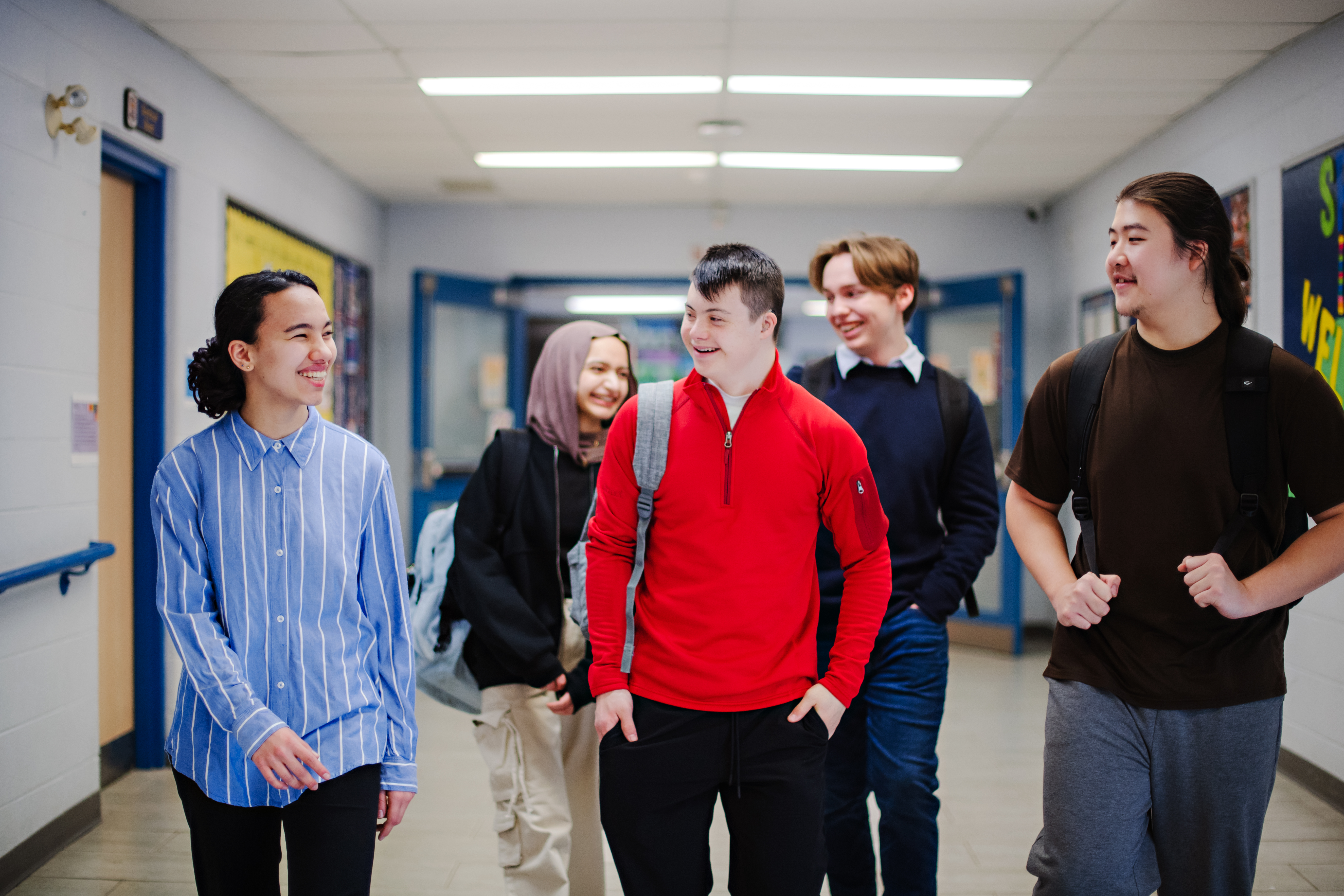 Teenagers in school hallway
