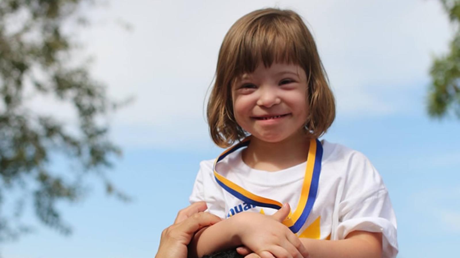 A young child smiles.