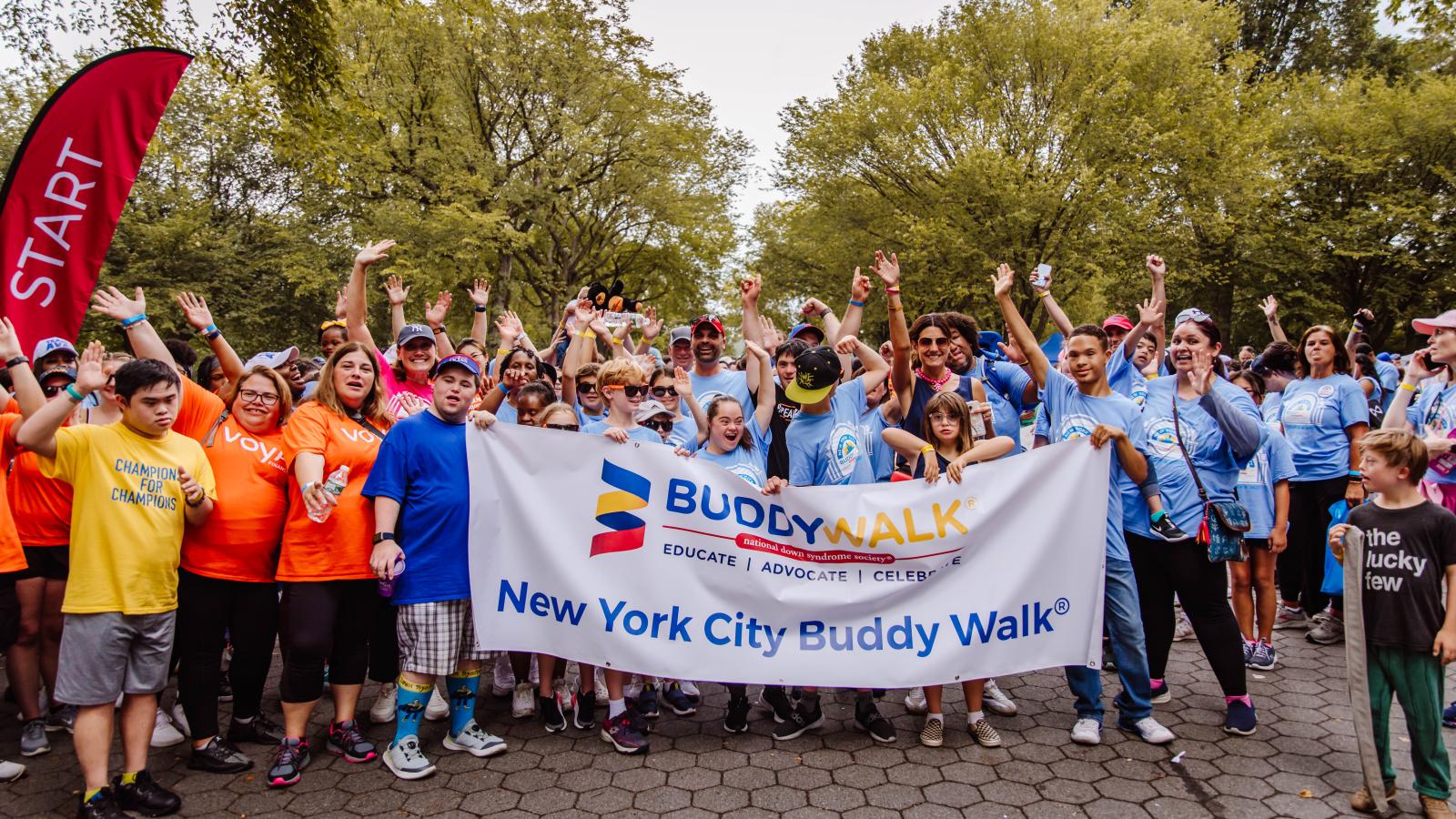 Start of the Buddy Walk with Grand Marshals holding the NYC Buddy Walk sign