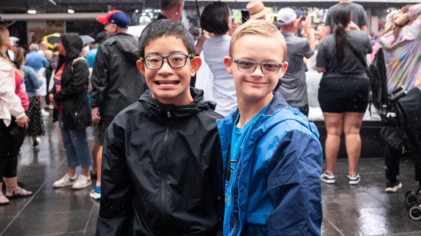 Two boys with glasses smile