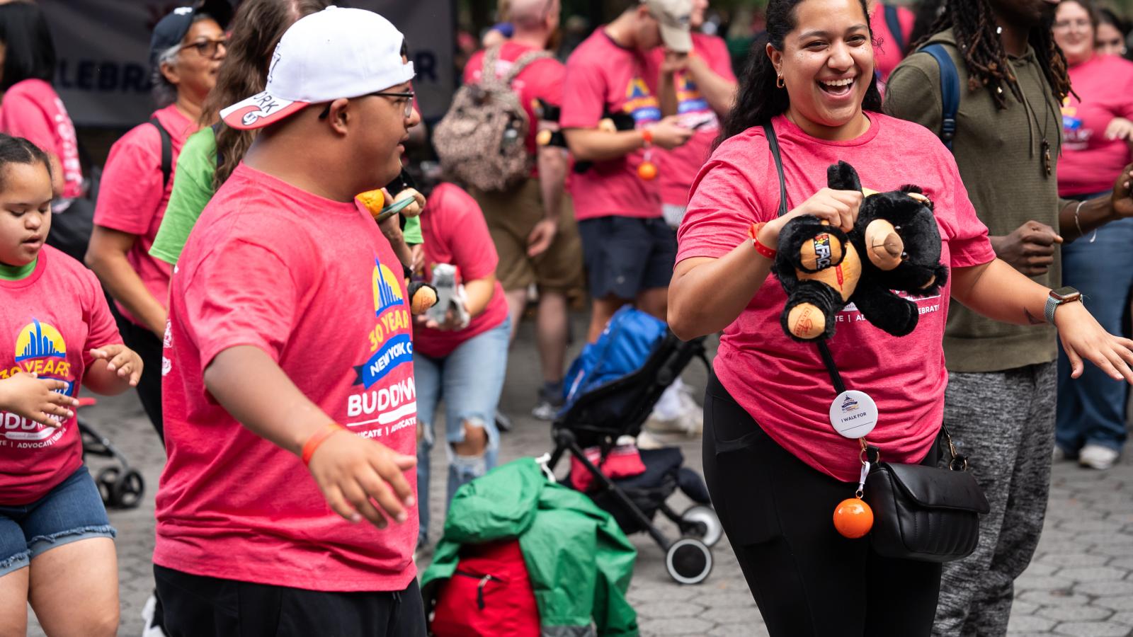 People at the Buddy Walk in red shirts celebrate