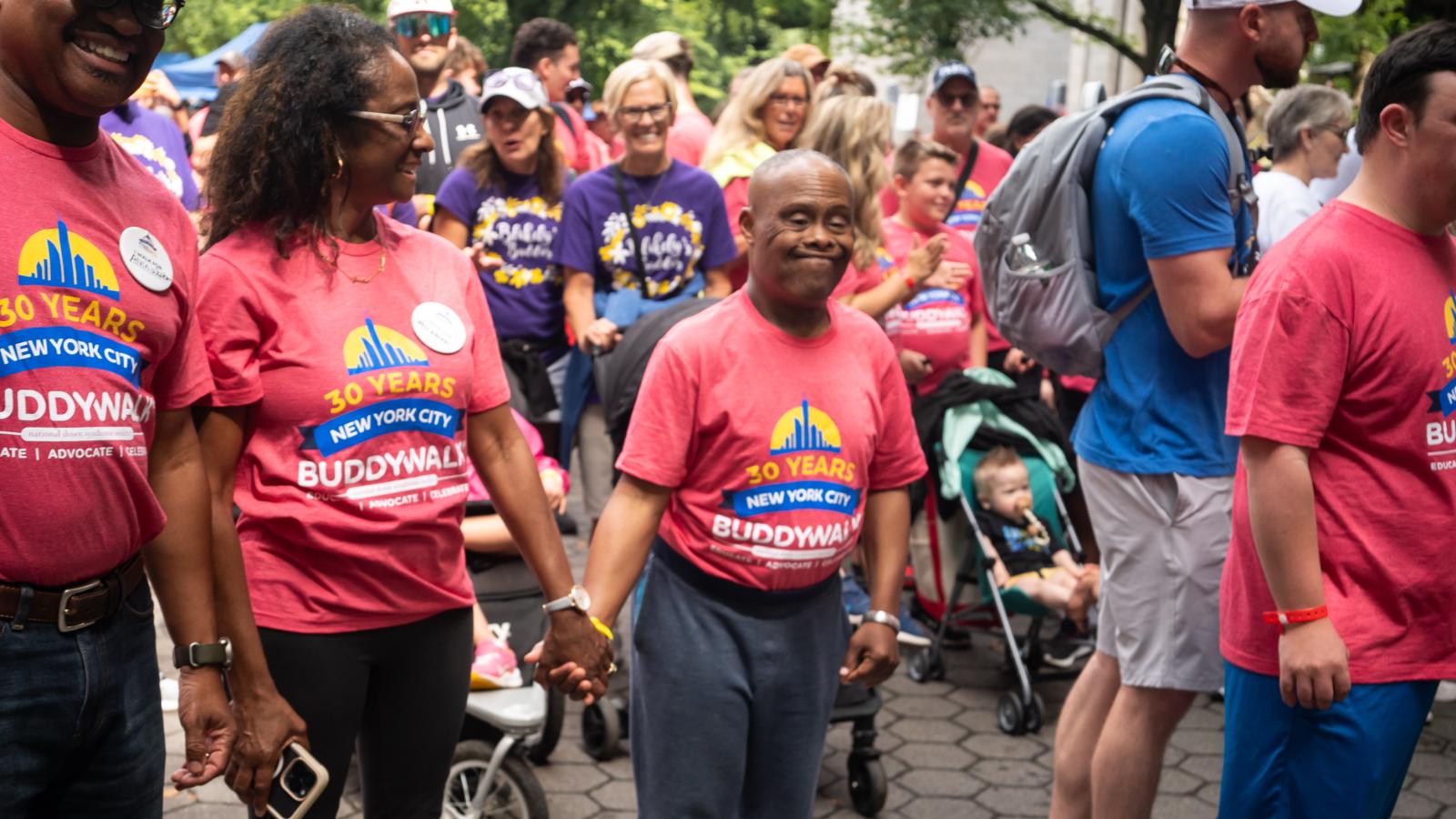 A Black man with Down syndrome and his family participate in the Buddy Walk