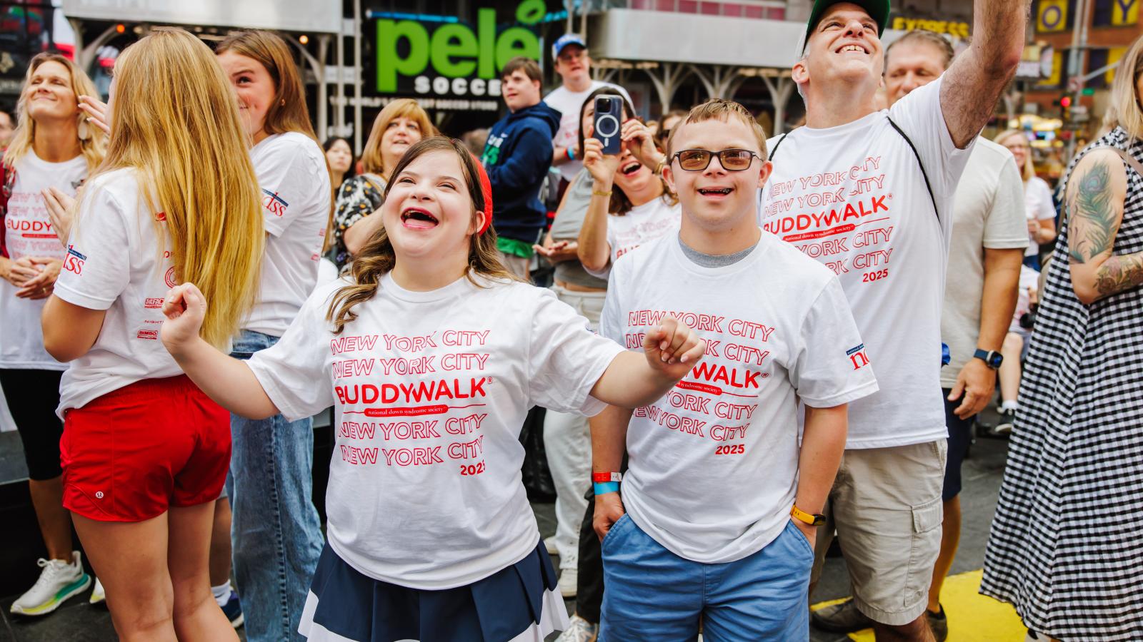 Individuals with Down syndrome wearing Buddy Walk t-shirts celebrate at Times Square 