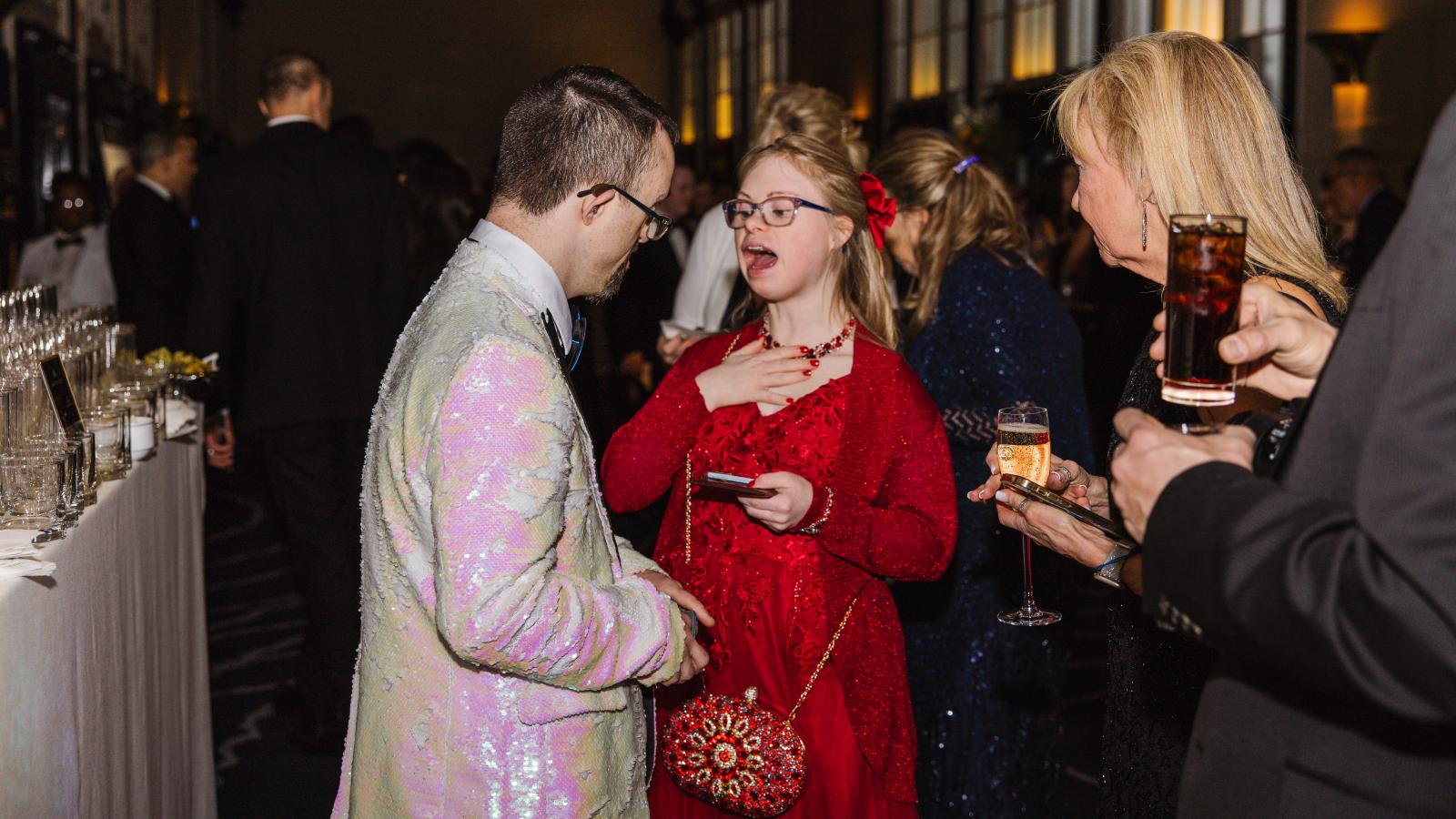 A young woman with Down syndrome and a man with Down syndrome talk with each other