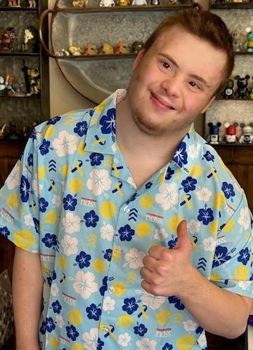 man with down syndrome wears down syndrome awareness Hawaiian shirts with the NDSS logo and blue and yellow colors