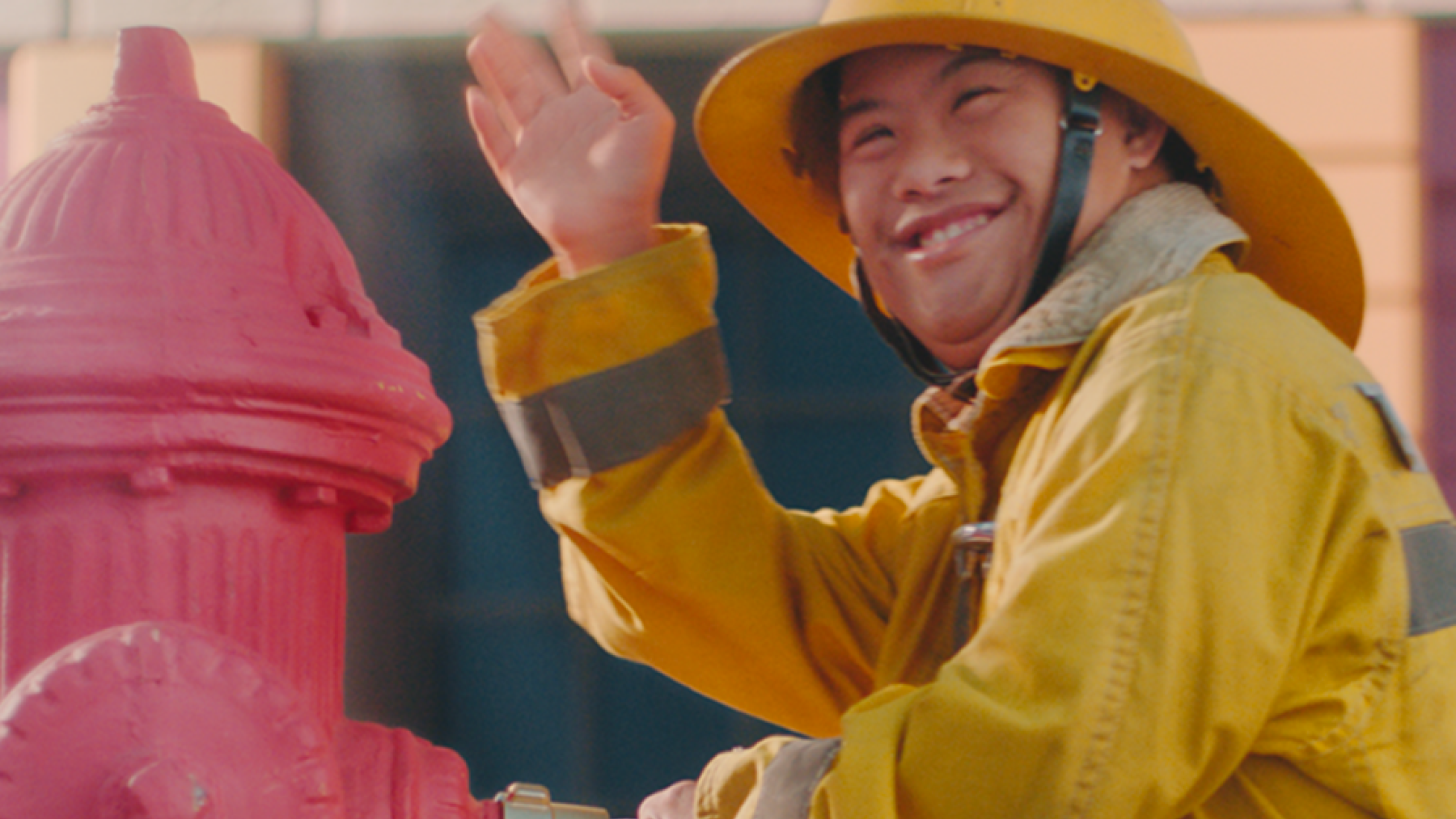 Man in firefighter gear next to fire hydrant