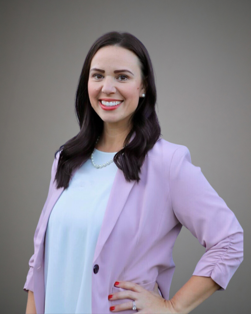 Headshot of Amy Drow, a woman with dark brown hair, wearing a white blouse and a light pink blazer.