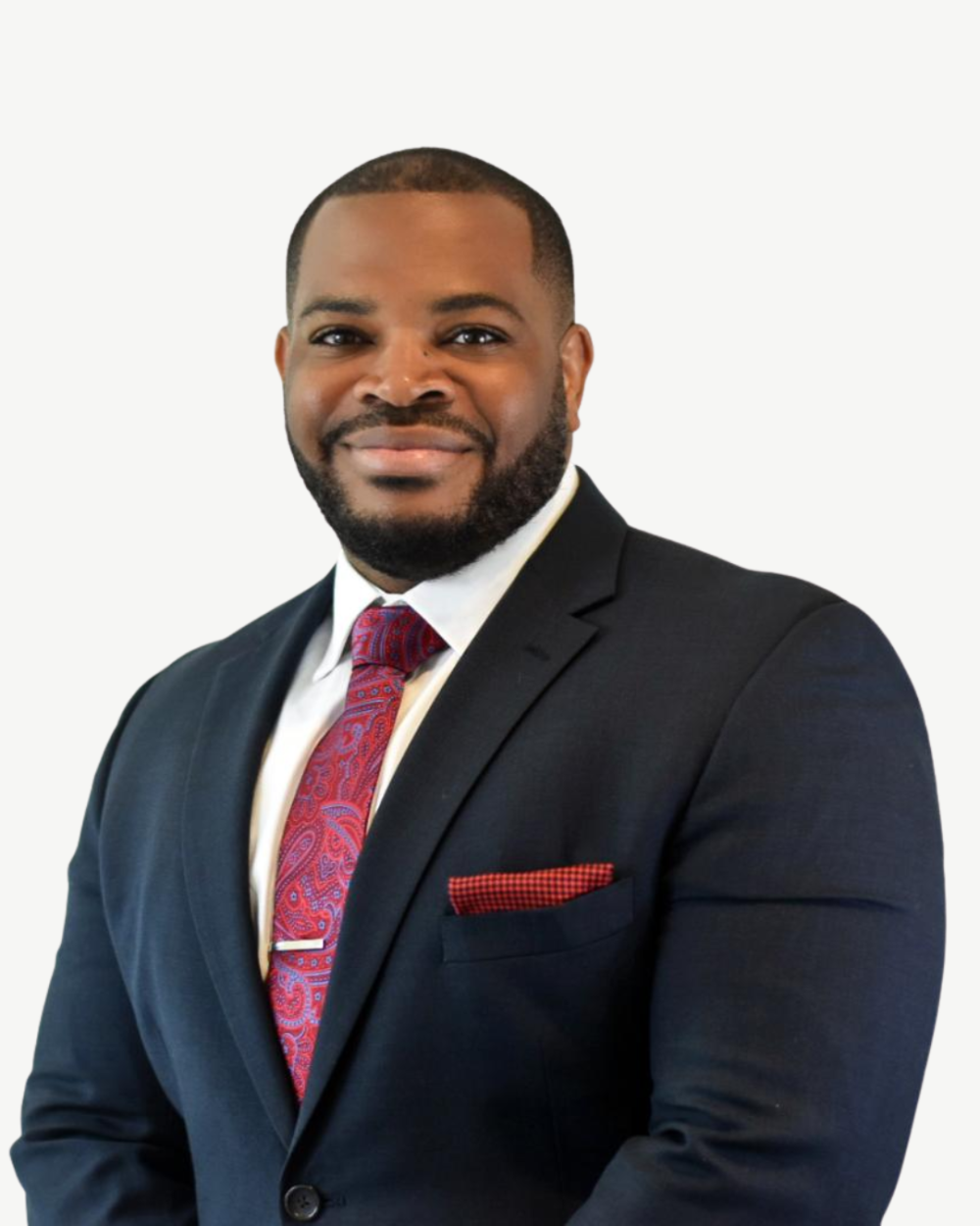 Headshot of C. Mitch Taylor, a man with black hair, wearing a white collar shirt, red hair, and a black suit jacket.