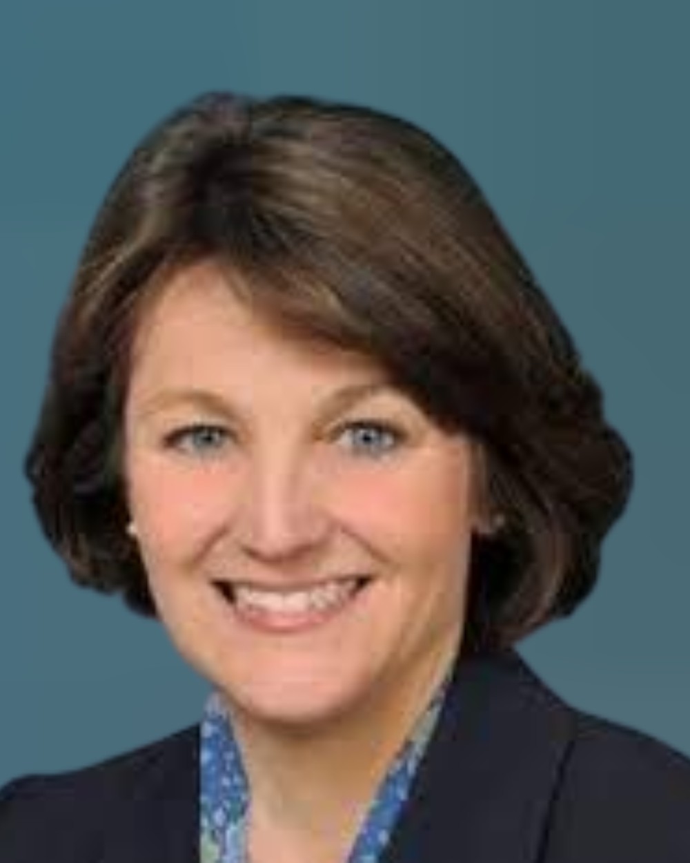 Headshot of Janet Slaughter Eissenstat, a woman with brown hair, wearing a multicolored blouse and black blazer.