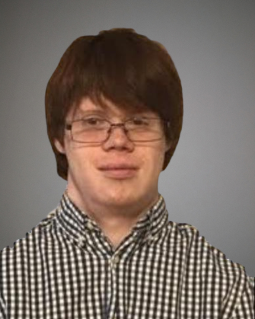 Headshot of Luke Hickey, a man with Down syndrome. He has brown hair and glasses and wears a checkered shirt.