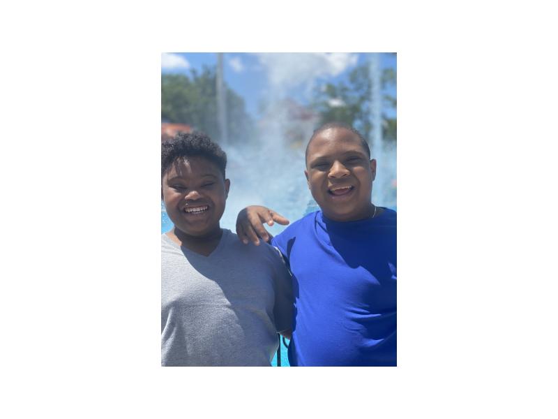 two young boys with Down syndrome smiling