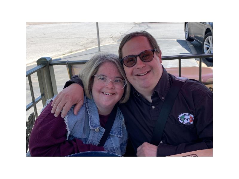 Man and woman with Down syndrome hugging