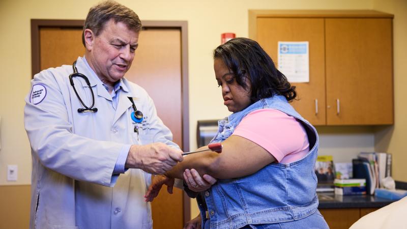 A woman with Down syndrome engages in an exam at the doctor's office