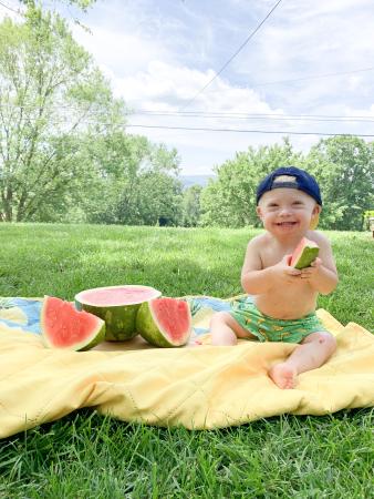 young boy with down syndrome eating watermelons