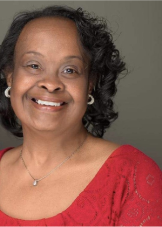 Older woman with Down syndrome smiles