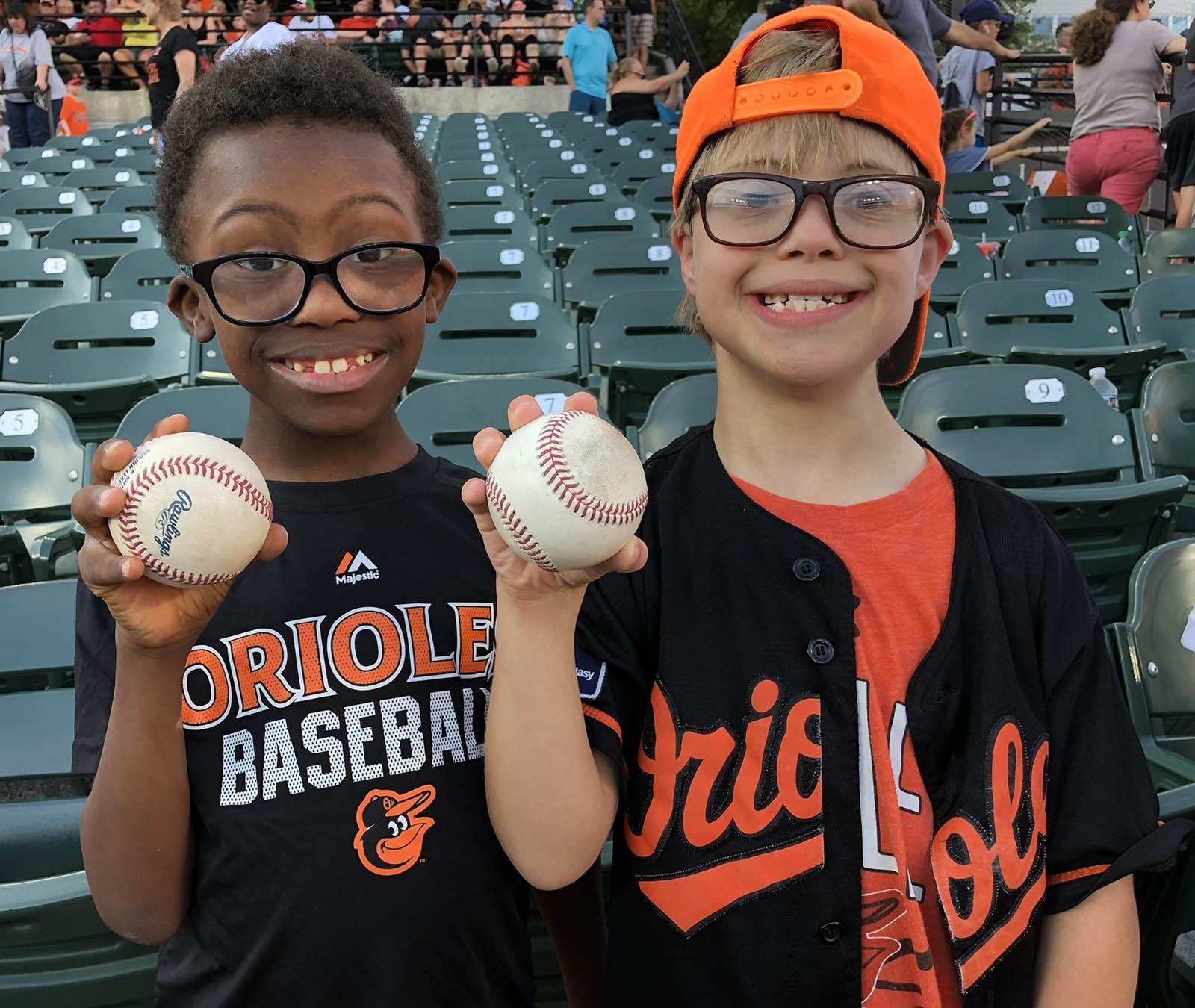 A pair child friends at baseball game