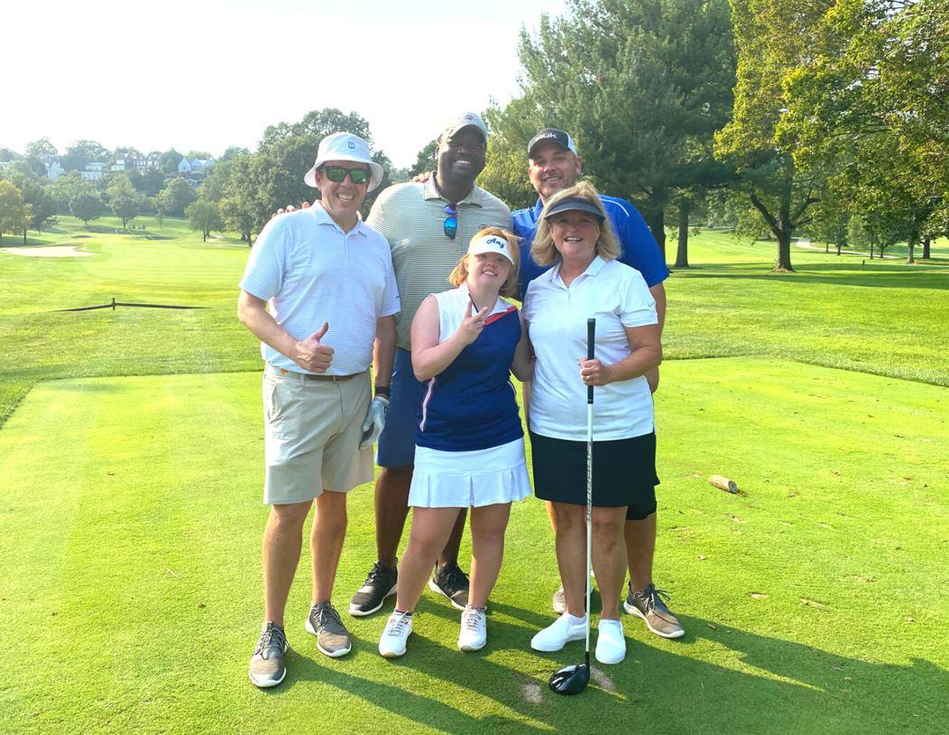 Group of golfers posing for photo on course