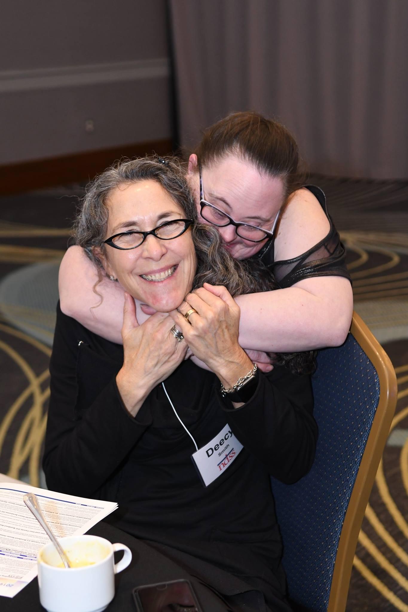 woman with down syndrome hugging her mother