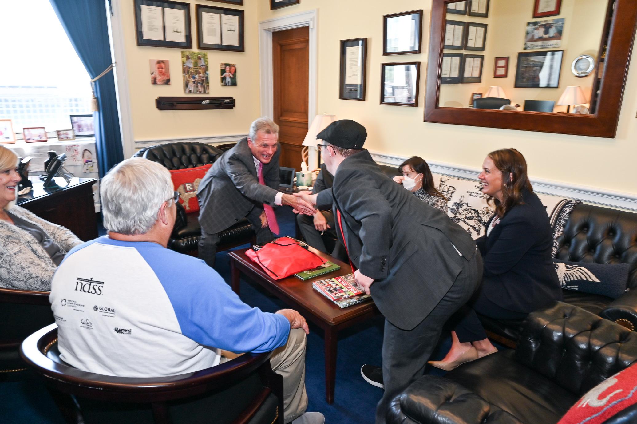 man with down syndrome shaking his member of congress' hand