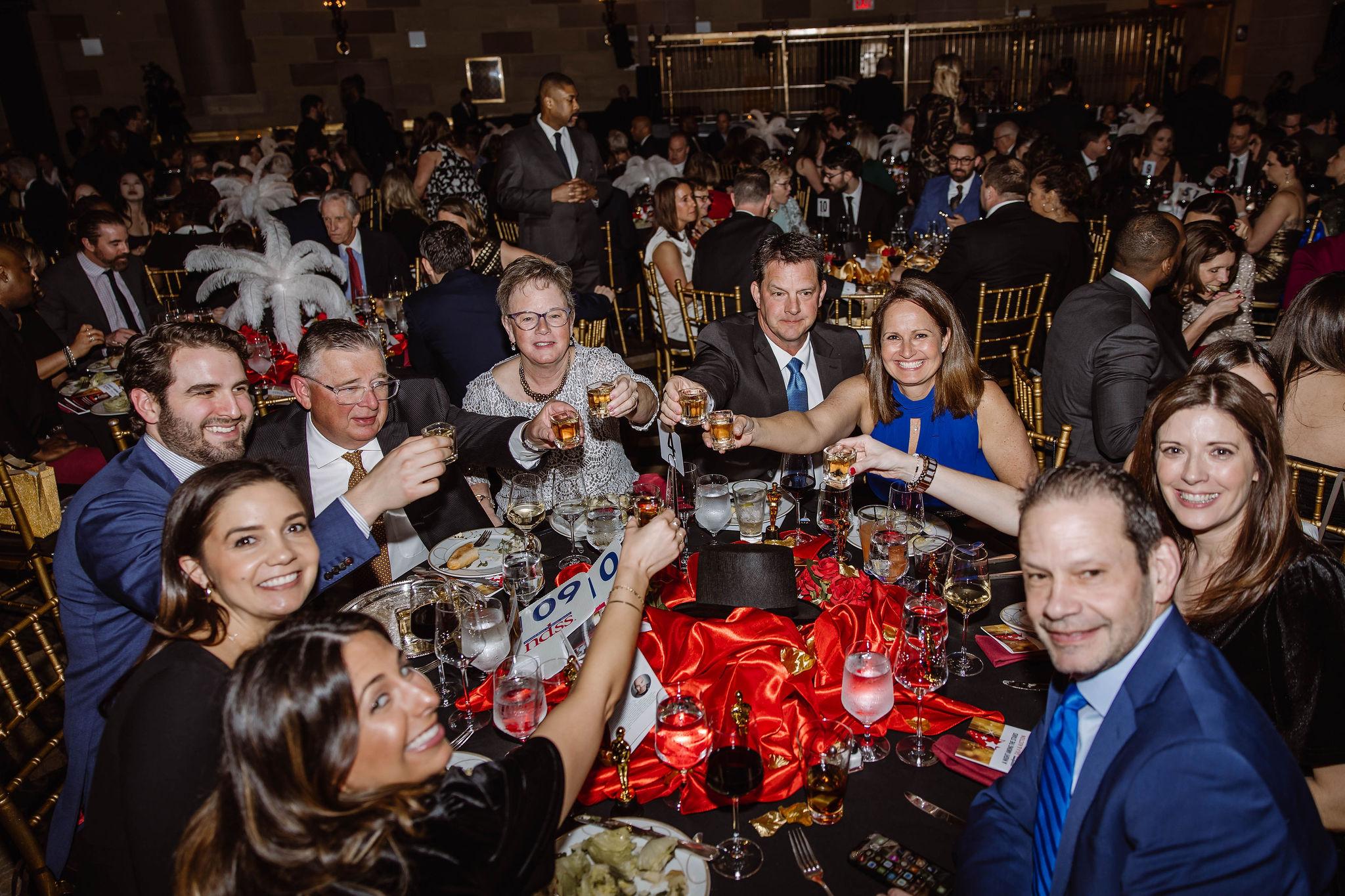 Image of a table of NDSS supporters celebrating at the gala