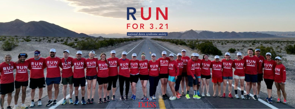 Run for 321 National Down Syndrome Society logo. Image of Team NDSS posing for a sunrise on a country road in the Western United States