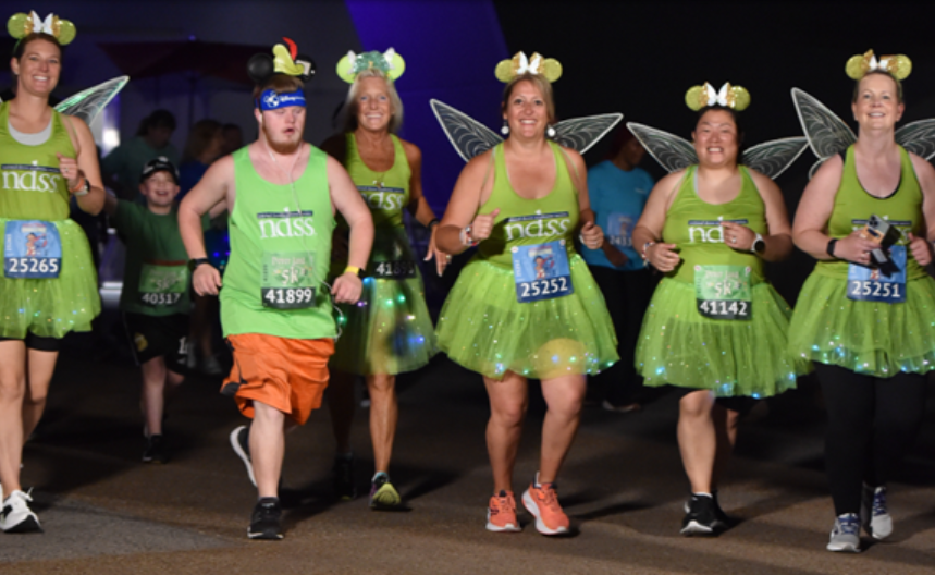 A group or NDSS runners wearing Tinkerbell costumes at Disney World