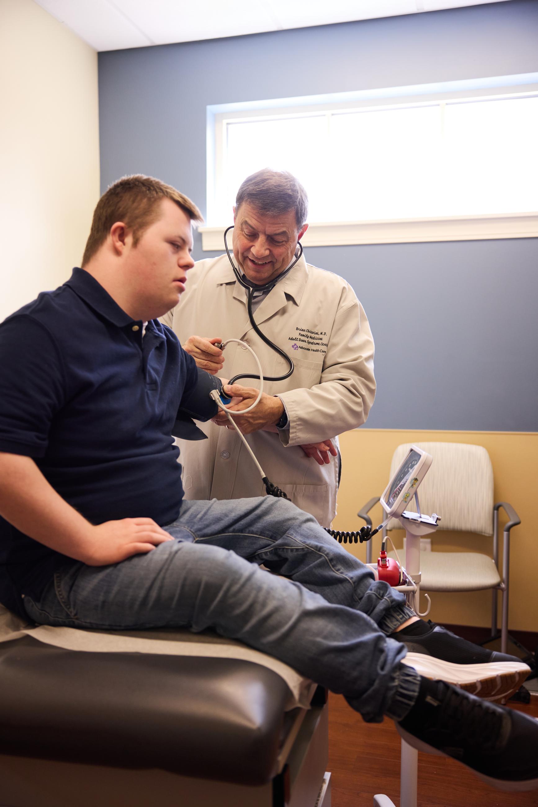 man with Down syndrome is with his doctor getting his vitals checked