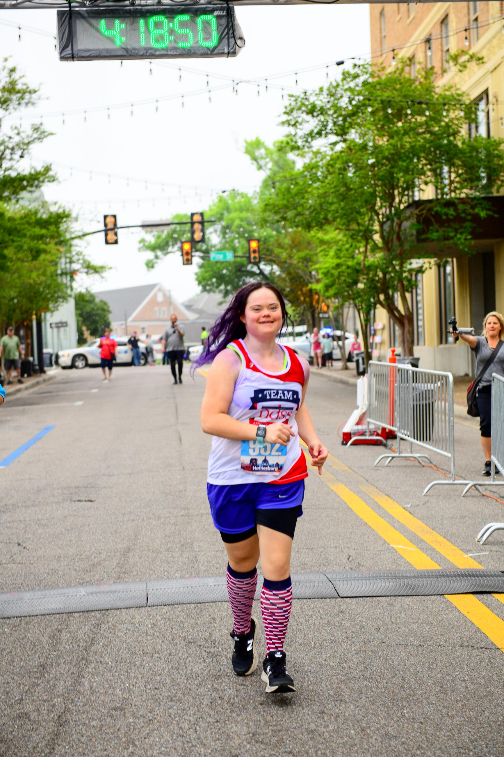 Woman with Down syndrome crossing a finish line