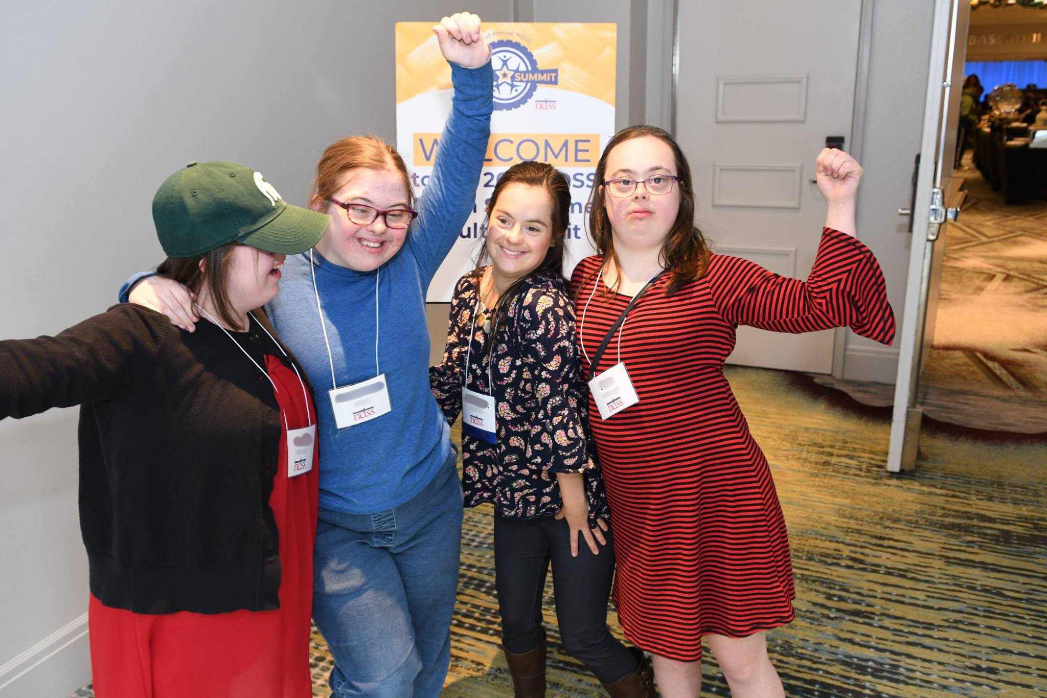 Group of friends, women with Down syndrome, posing for a picture at a conference