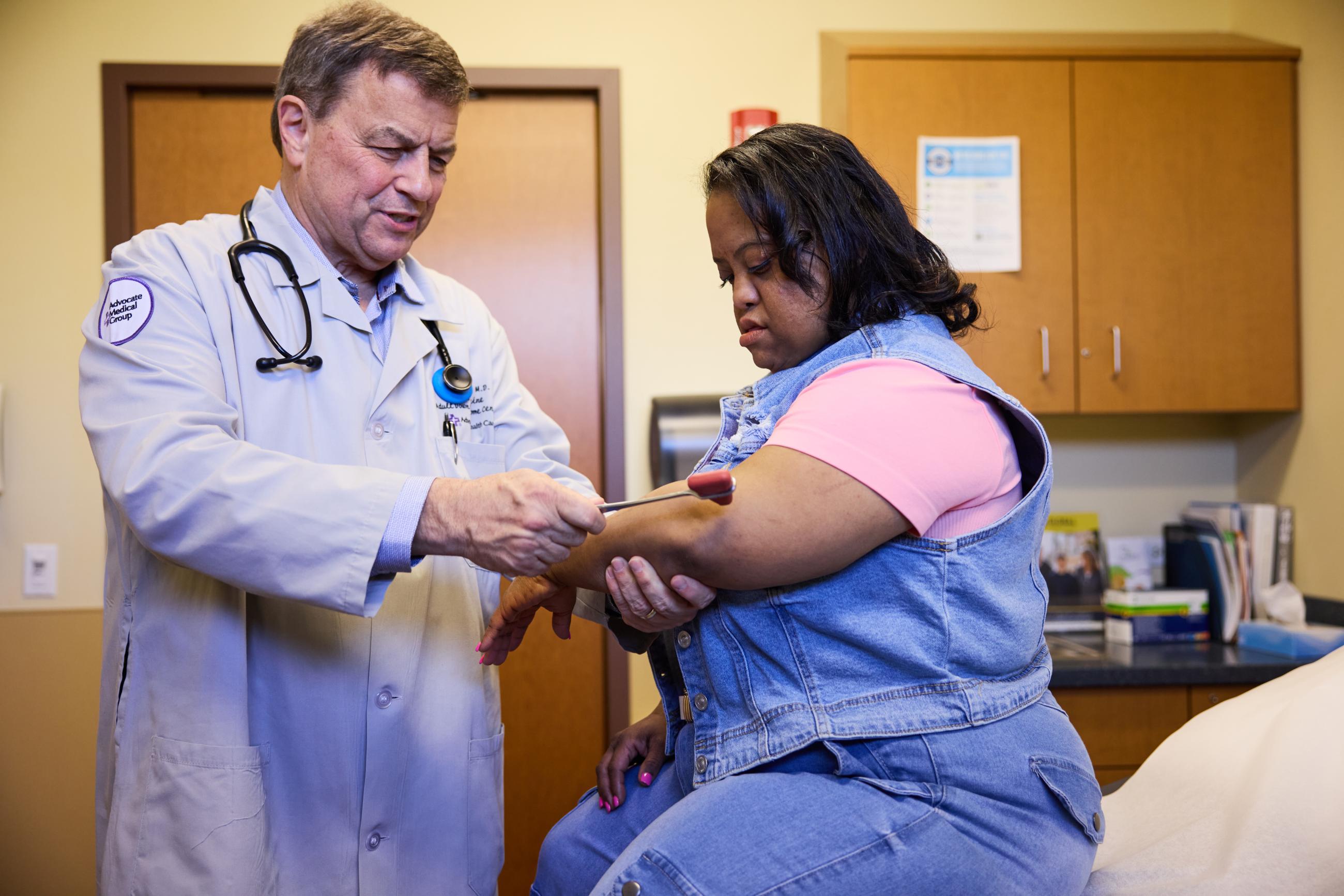 A doctor tests a woman with Down syndrome's reflexes