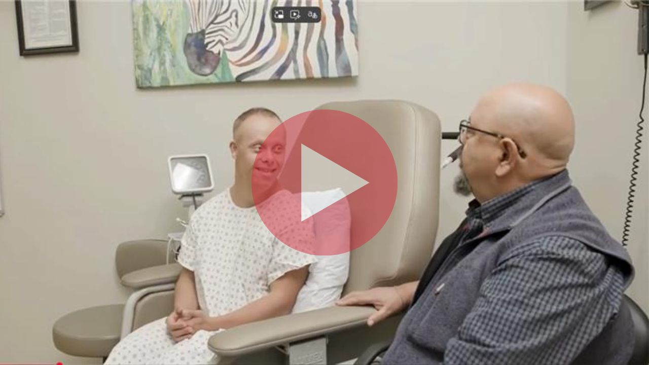 A video that shows a man with Down syndrome and his father at the doctor's office
