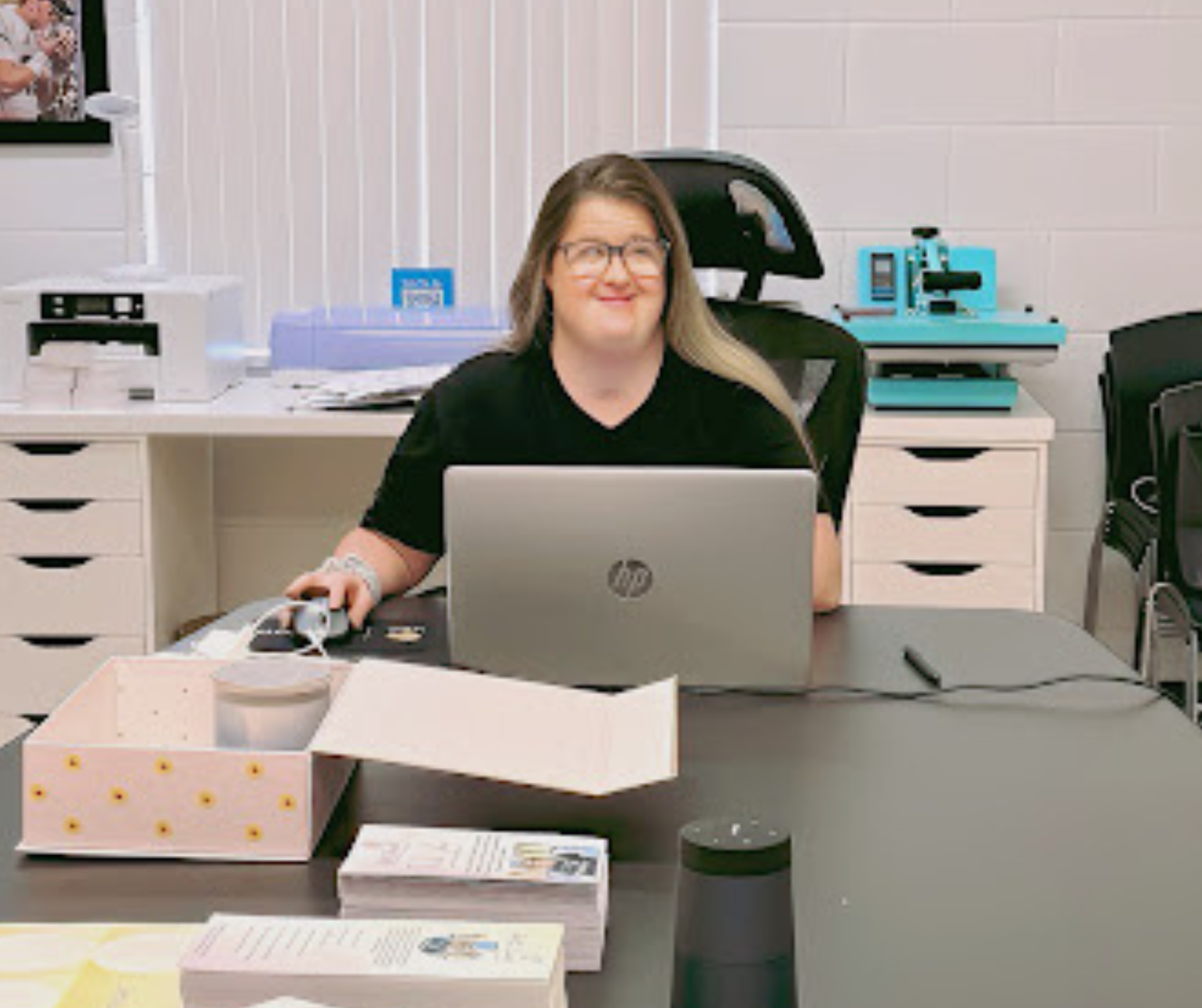 Britt, a woman with Down syndrome, works at her computer.