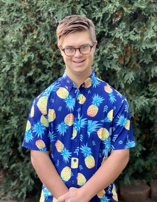 man with down syndrome smiling in a Hawaiian shirt 