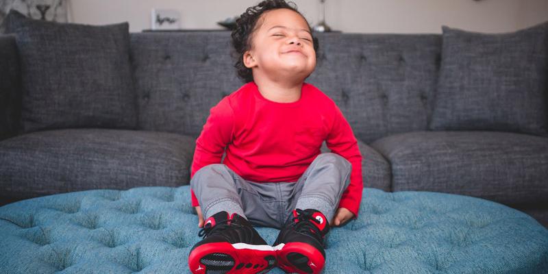 Young Miles smiling on a couch